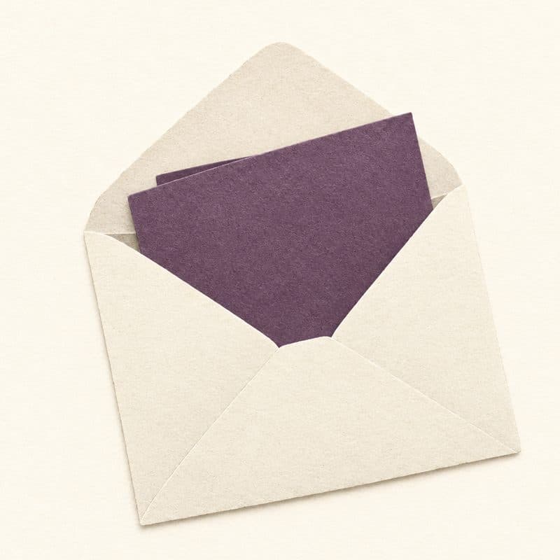 Cut-paper illustration: an open ivory envelope with a folded plum note half pulled out.